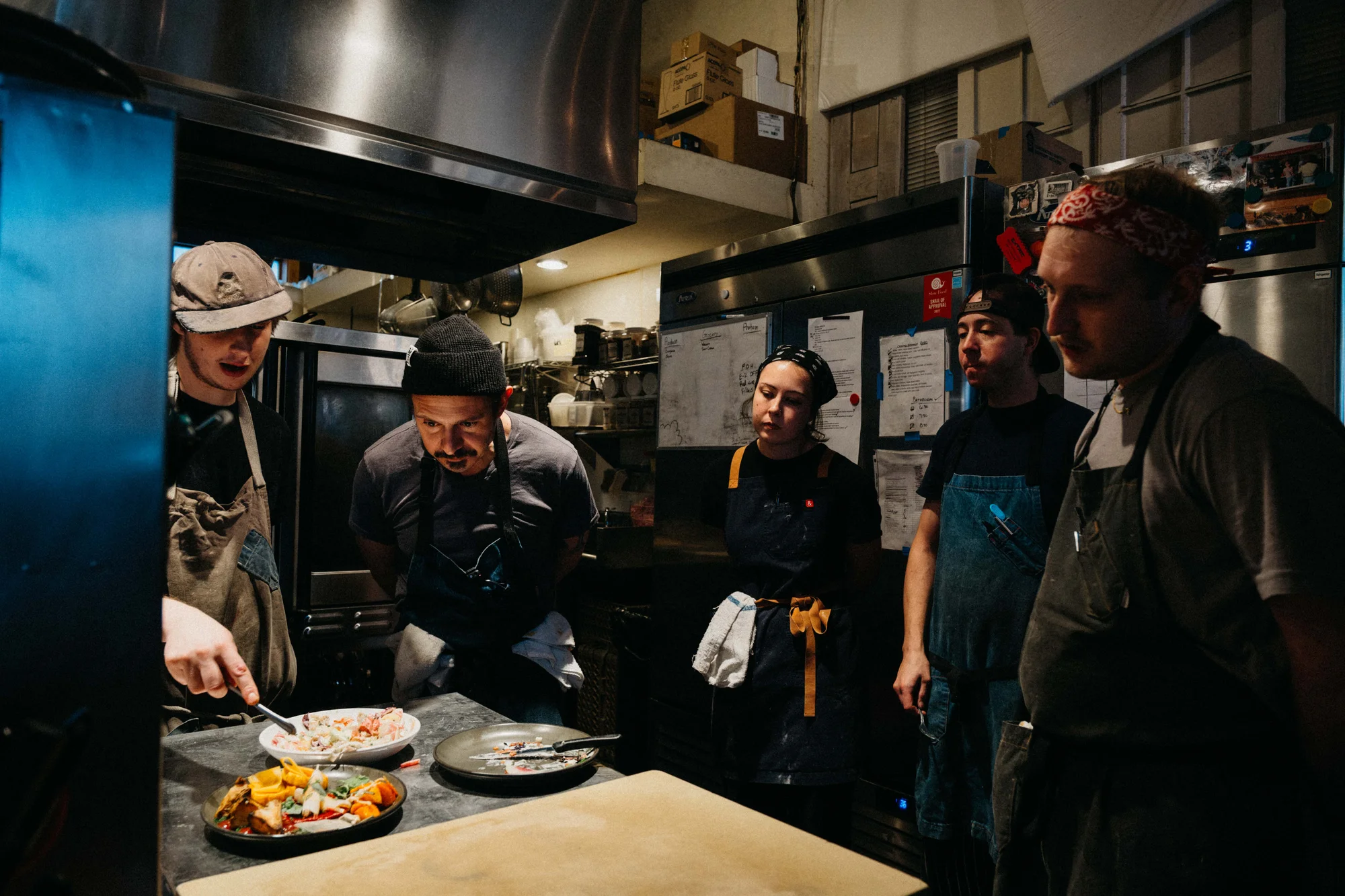 Paul Warthen tastes the specials of the day with the other chefs in the kitchen. Photo: Peter Vo, Rocky Mountain PBS