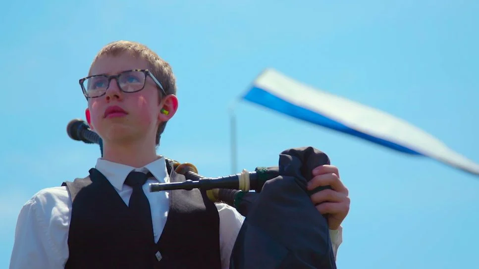 A young piper stands with his pipes at the ready before competition. Photo: Chase McCleary, Rocky Mountain PBS