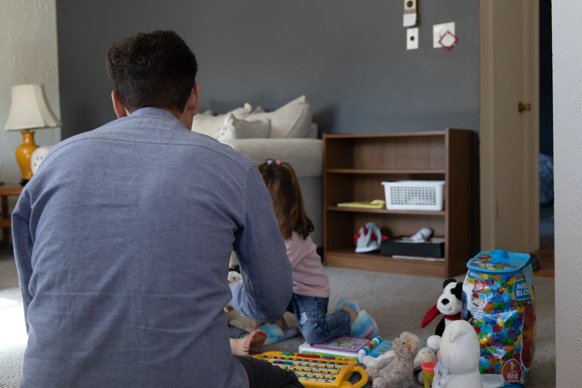 Hedayat Yar helps his four-year-old daughter learn English. She has been adjusting well to her new life in the U.S., but her two-year-old brother has struggled.  Photo: Andrea Kramar, Rocky Mountain PBS