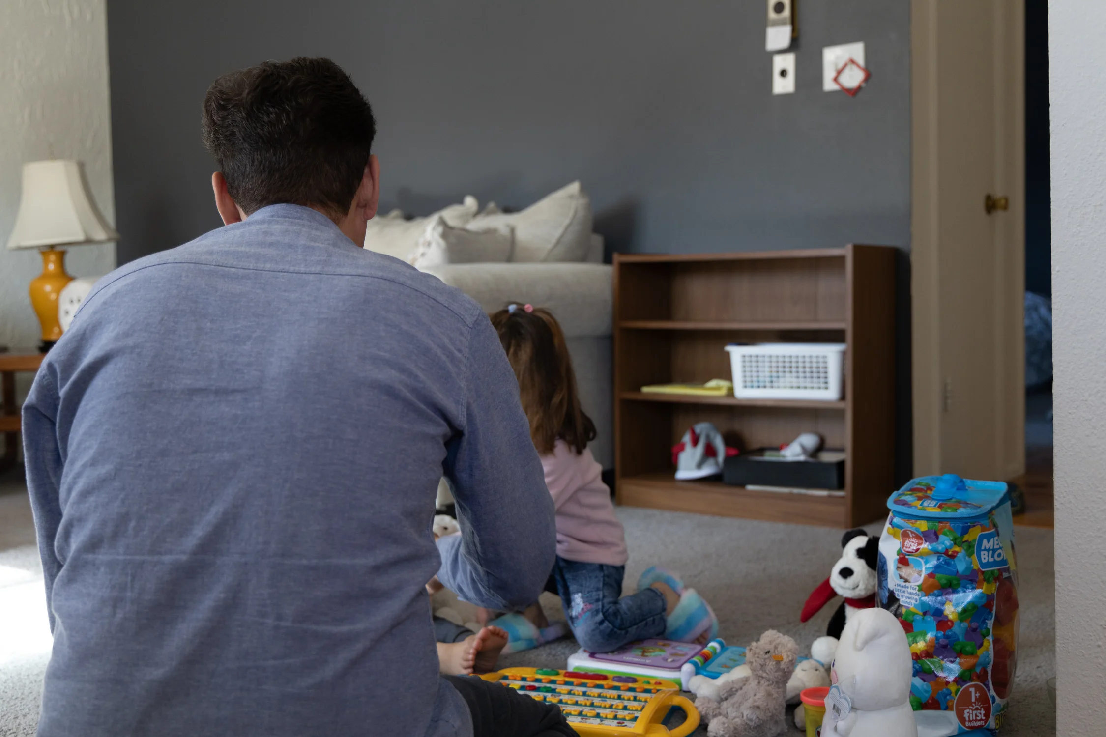 Hedayat Yar helps his four-year-old daughter learn English. She has been adjusting well to her new life in the U.S., but her two-year-old brother has struggled.  Photo: Andrea Kramar, Rocky Mountain PBS