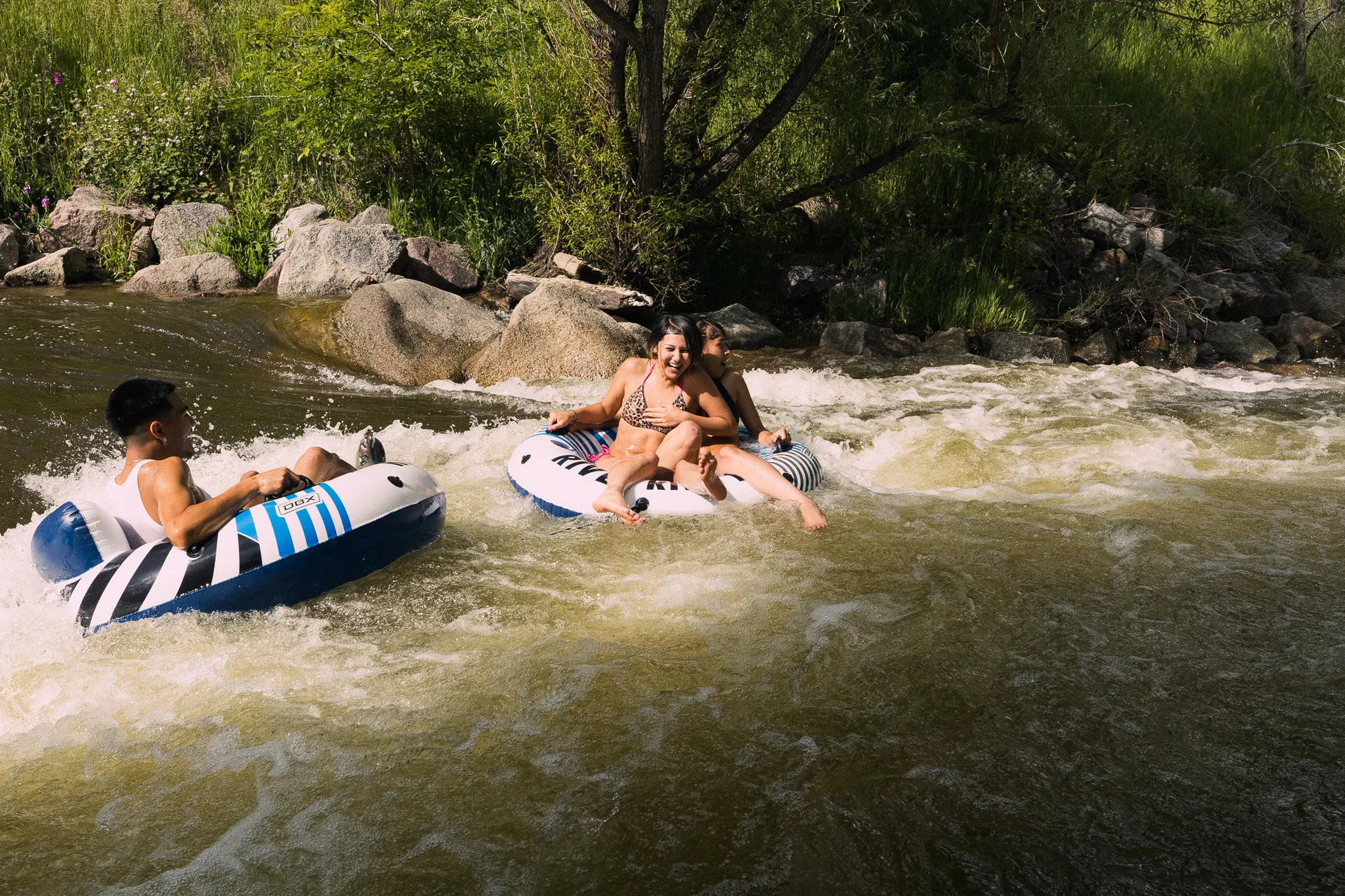 Michael Maestas (left) and his friends tube Boulder Creek in early-June.