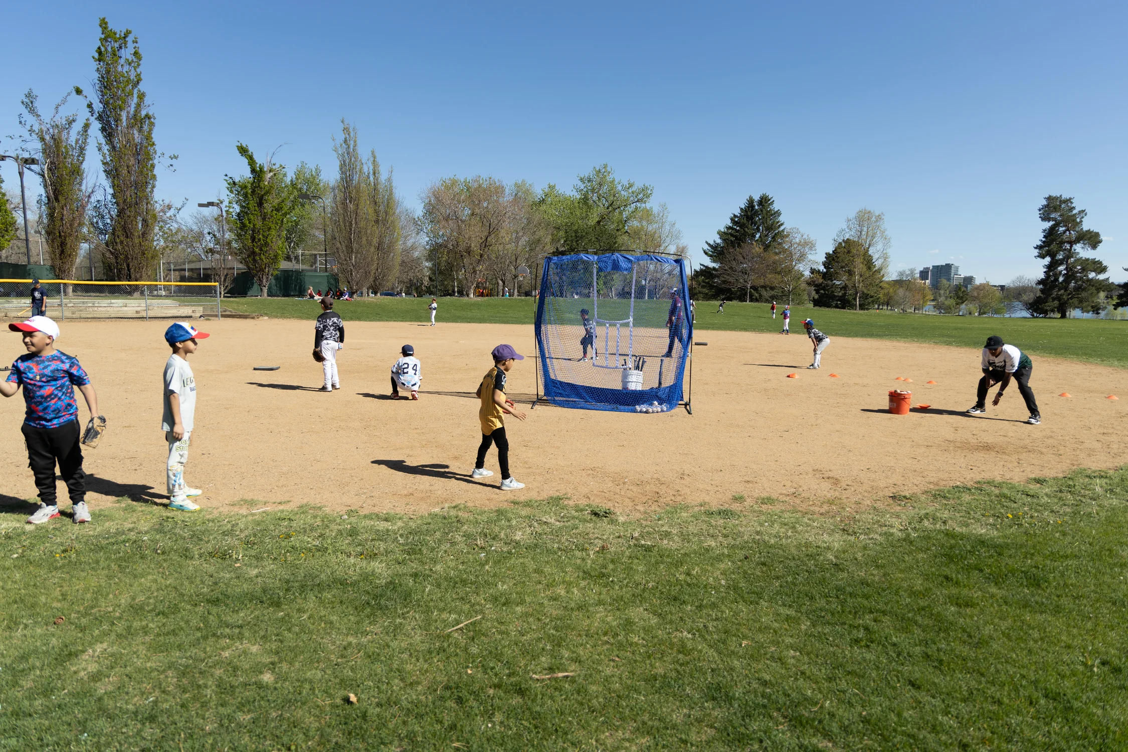 During practice kids learn how to field ground balls, throw, hit, run bases and as Ramos hopes they’ll learn a little more outside the game too. Photo: Amanda Horvath, Rocky Mountain PBS