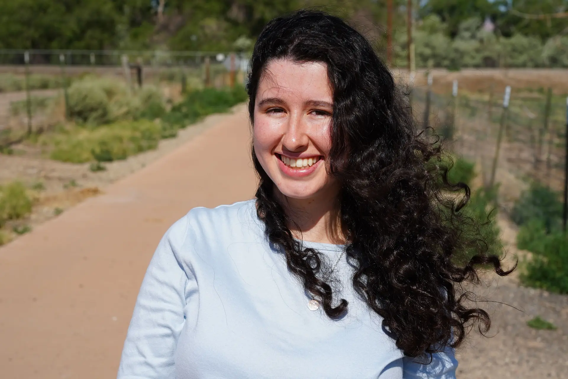 Hill poses for a photo on the trail near her piece. Photo: Joshua Vorse, Rocky Mountain PBS