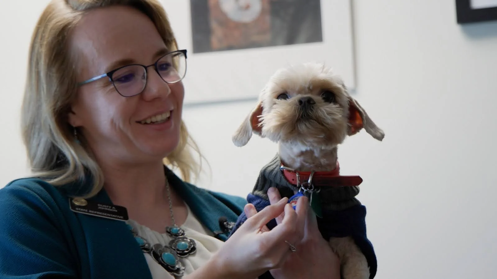 State Rep. Dusty Johnson, R-Fort Morgan, and her dog, Peaches, in Johnson’s Colorado Capitol office.  Photo: Andrea Kramar, Rocky Mountain PBS