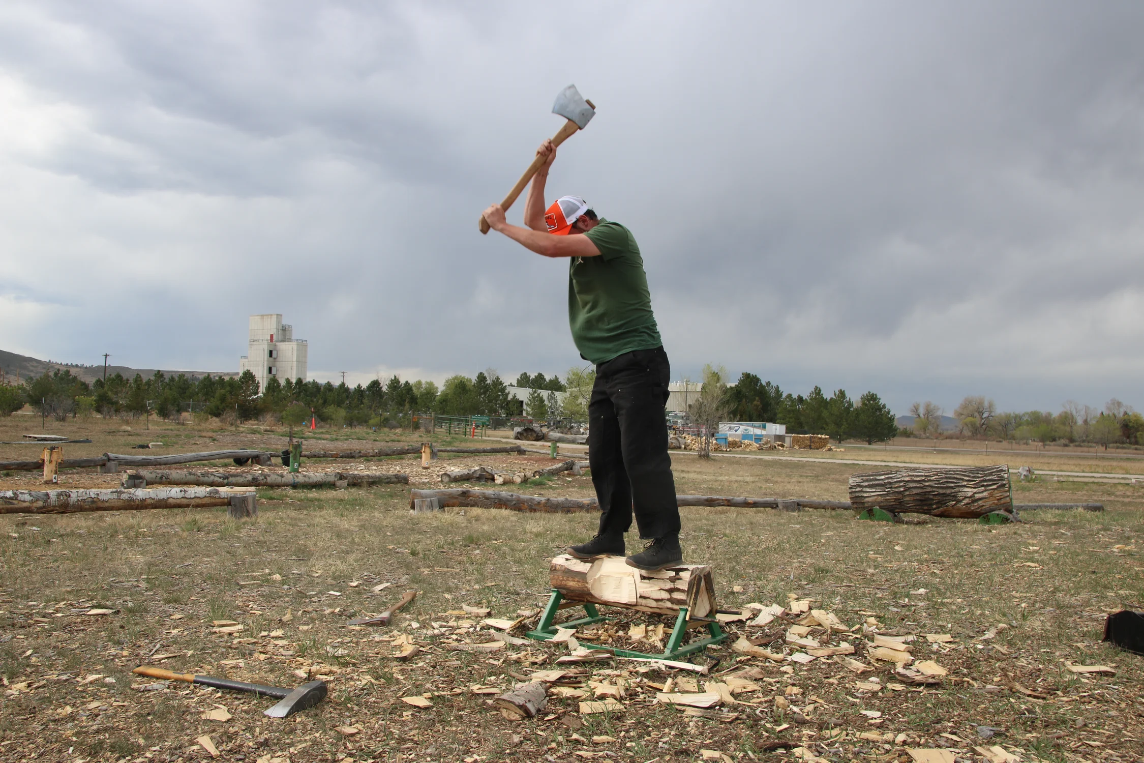 Senior and Logging Sports Club President Troy Ferguson stands on top of a log to practice the horizontal chop event. It focuses around swinging an axe in-between your feet. Photo: Emma VandenEinde, KUNC