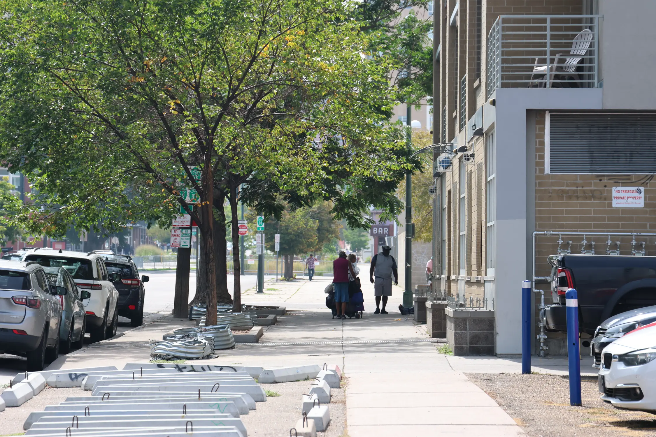 Concrete parking blocks, planters filled with stones and ledges topped with decorative spikes line the sidewalk outside Curtis Street Lofts. Photo: Kyle Cooke, Rocky Mountain PBS