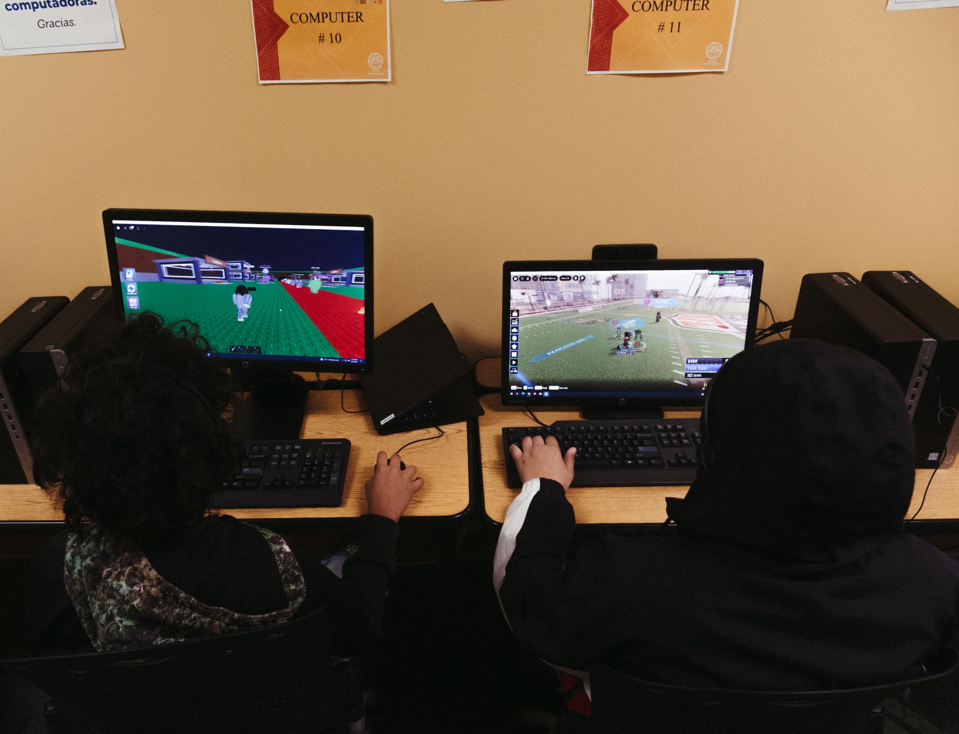 Two students play Roblox on computers at the Iliff Square branch. Photo: Peter Vo, Rocky Mountain PBS