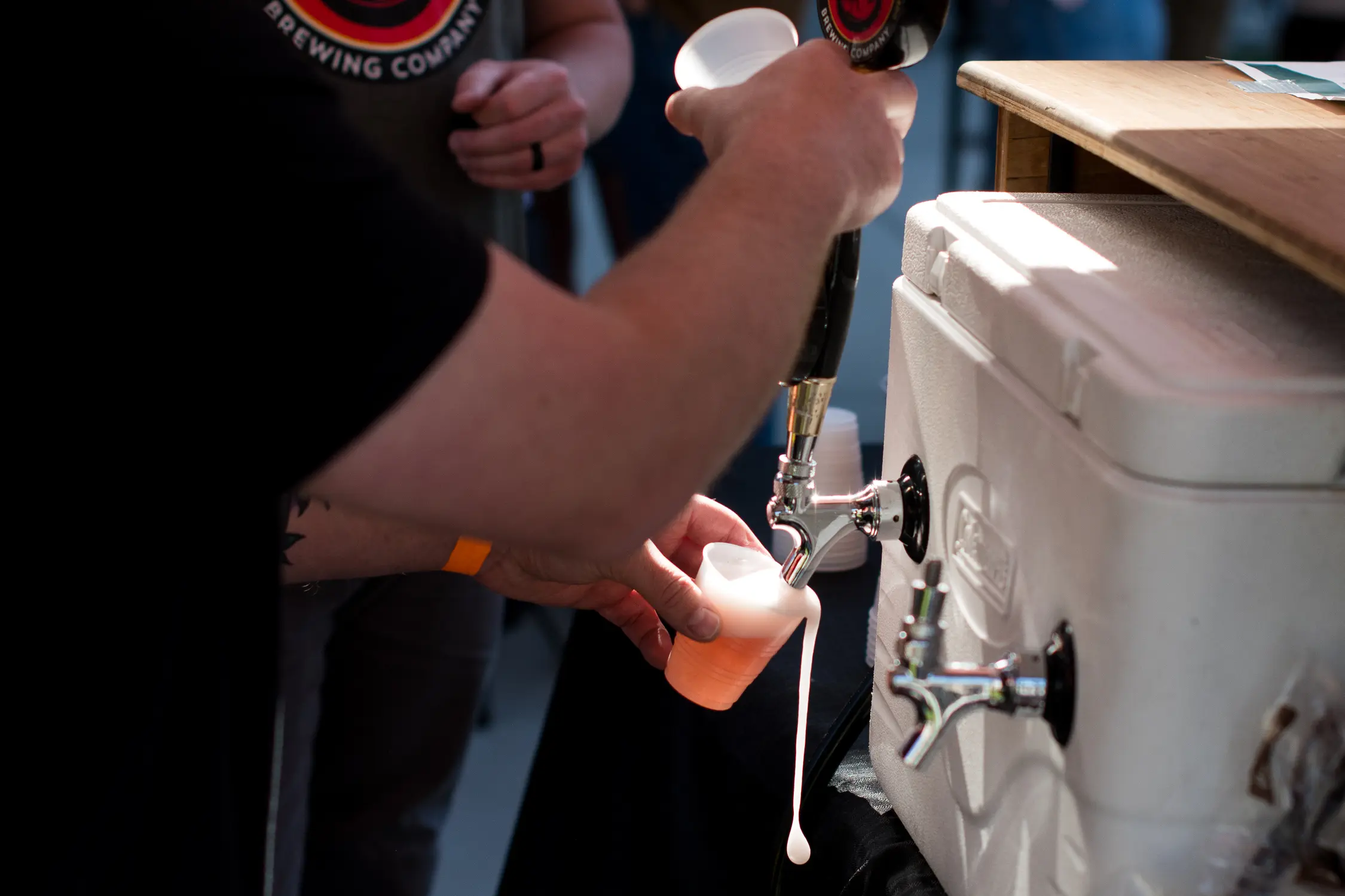 Brewers with Horse and Dragon Brewing Company pour their team’s beer at the 2025 Iron Brew Competition. Photo: Cormac McCrimmon, Rocky Mountain PBS