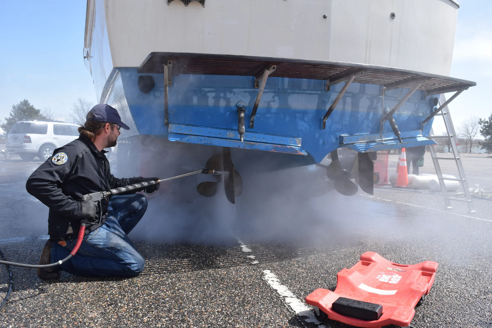 A Colorado Parks and Wildlife employee decontaminates a boat suspected of harboring aquatic nuisance species. Photo courtesy Colorado Parks and Wildlife. 