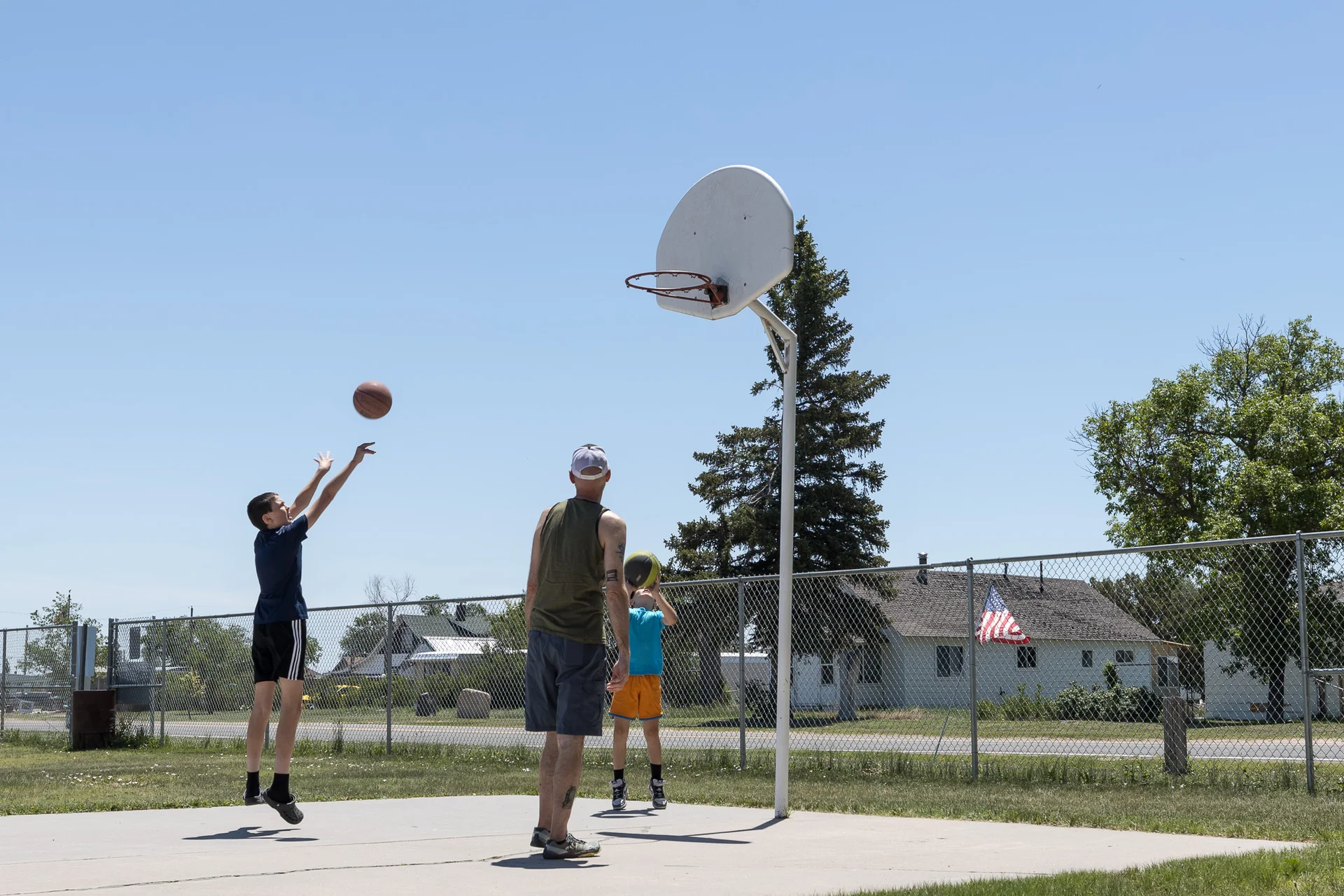 Brian Kughman plays basketball with his kids in Grover.