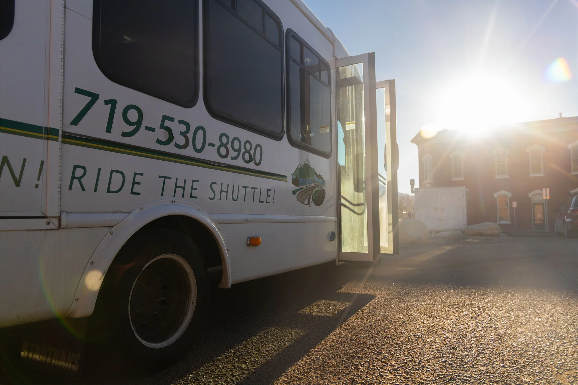 “Go Green! Ride the Shuttle!” is written across Mountain Valley Transit’s old shuttle wraps. Photo: Chase McCleary, Rocky Mountain PBS