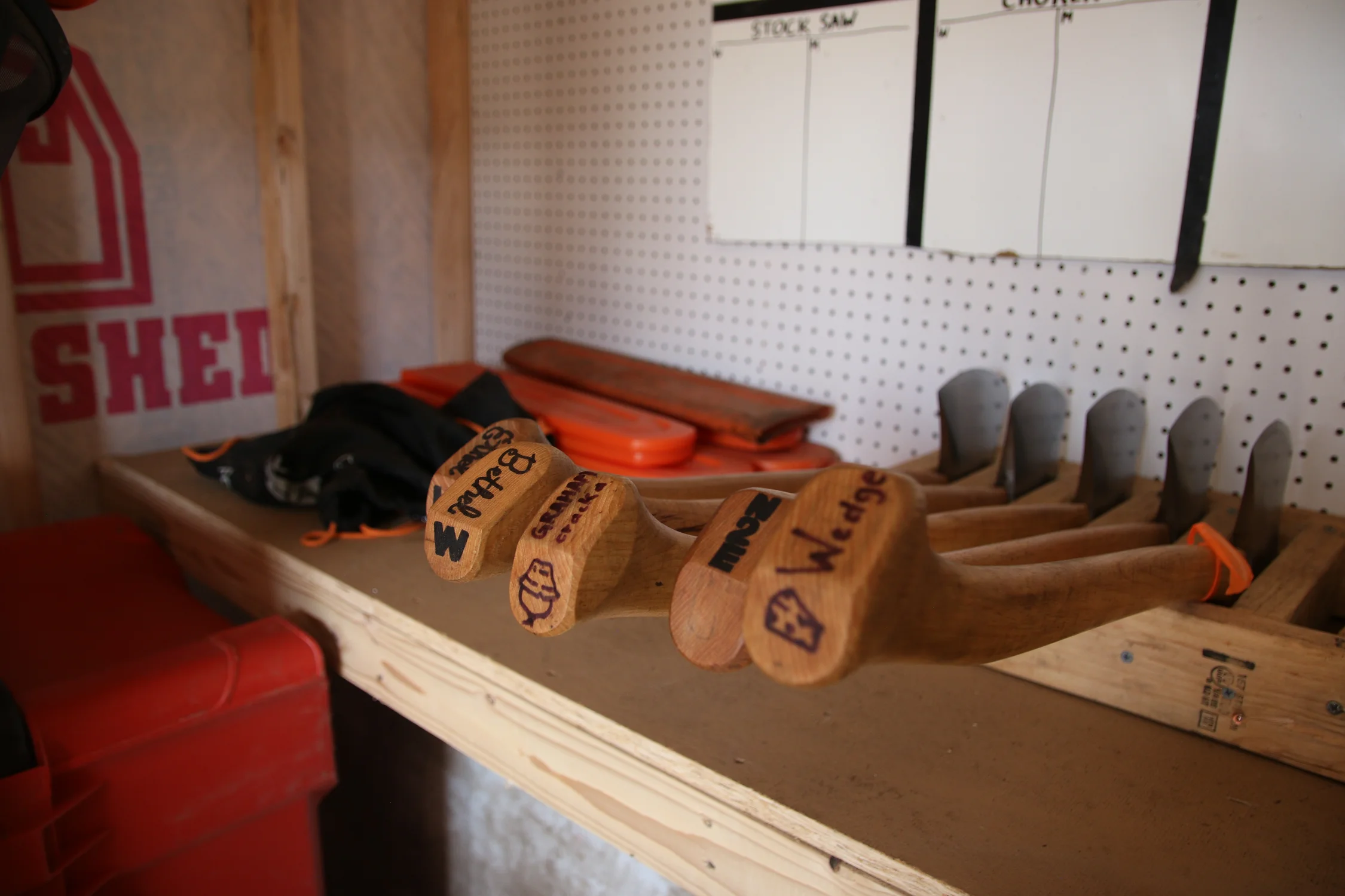 Many of the logging sports team members add names to their axes. Some of the names are puns on axe terminology, and others are just whatever the student wanted them to be called. Photo: Emma VandenEinde, KUNC