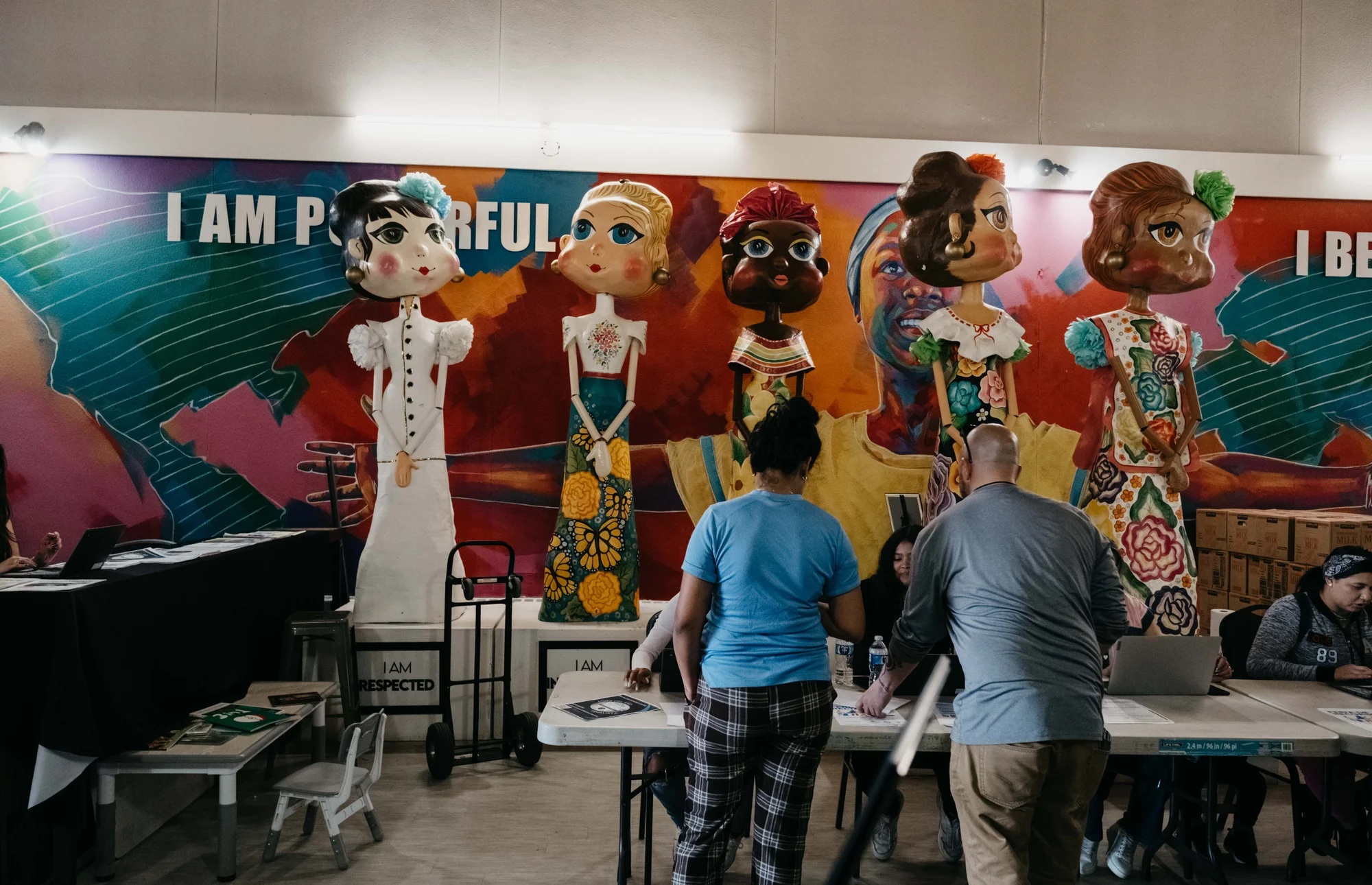 A couple signs into the center before receiving food items. Photo: Peter Vo, Rocky Mountain PBS