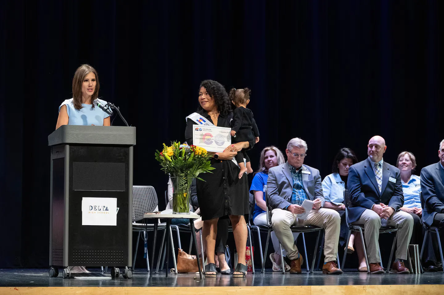 Janet Damon is awarded the 2025 Colorado Teacher of the Year award from Denver 7 anchor Nicole Brady. Photo courtesy Valerie Mosley, Colorado Department of Education