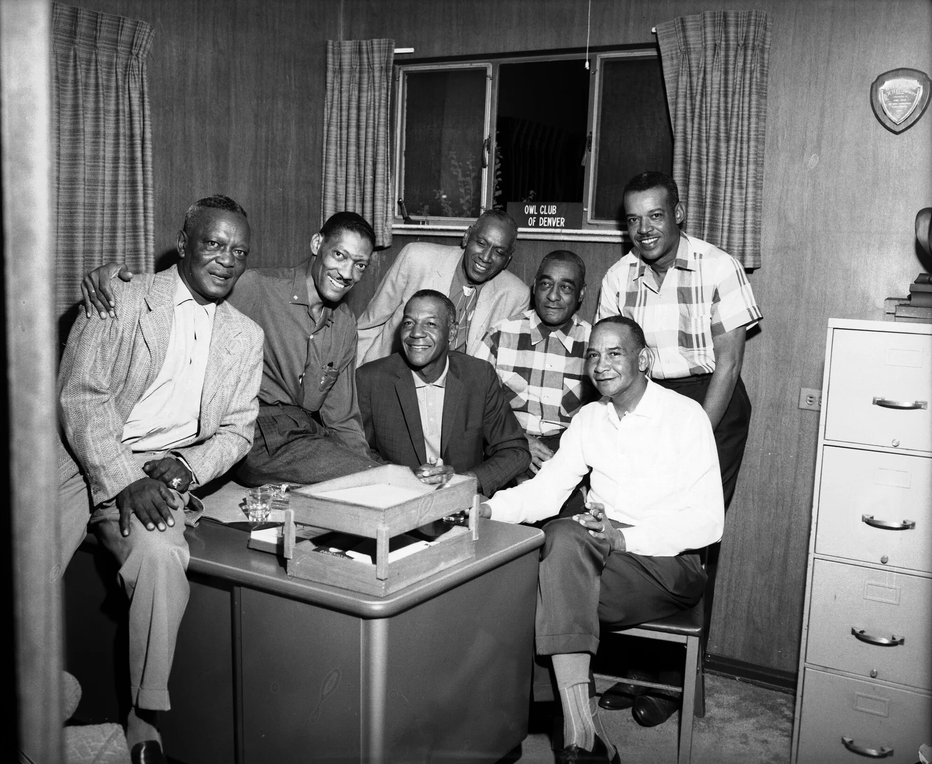 Owls, or Owl Club members, at a desk in the Owl Club House office. The Owl Club got its name because the members’ wives, called Owlettes, said the men, who stayed up late playing cards, were night owls. Photo courtesy Denver Public Library Digital Collections