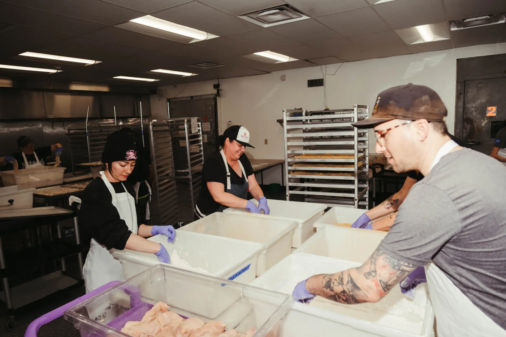 Cooks bread chicken for the chicken parmesan dish on The Spicy Radish's weekly menu. Photo: Peter Vo, Rocky Mountain PBS