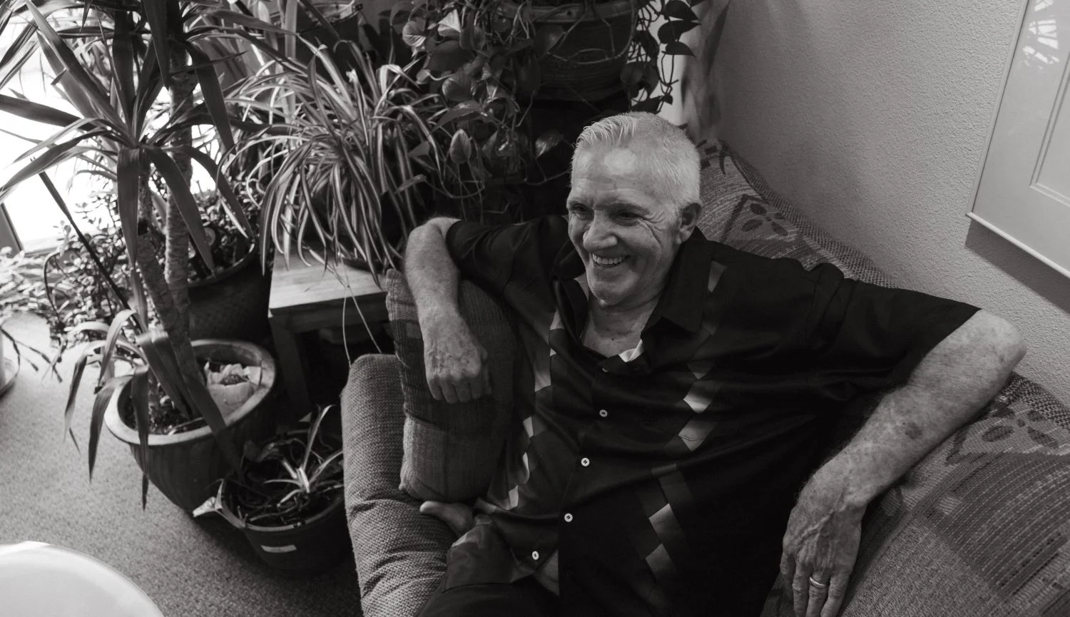 Christopher Sloan sits on his couch at Chesney-Kleinjohn. Photo: Peter Vo, Rocky Mountain PBS