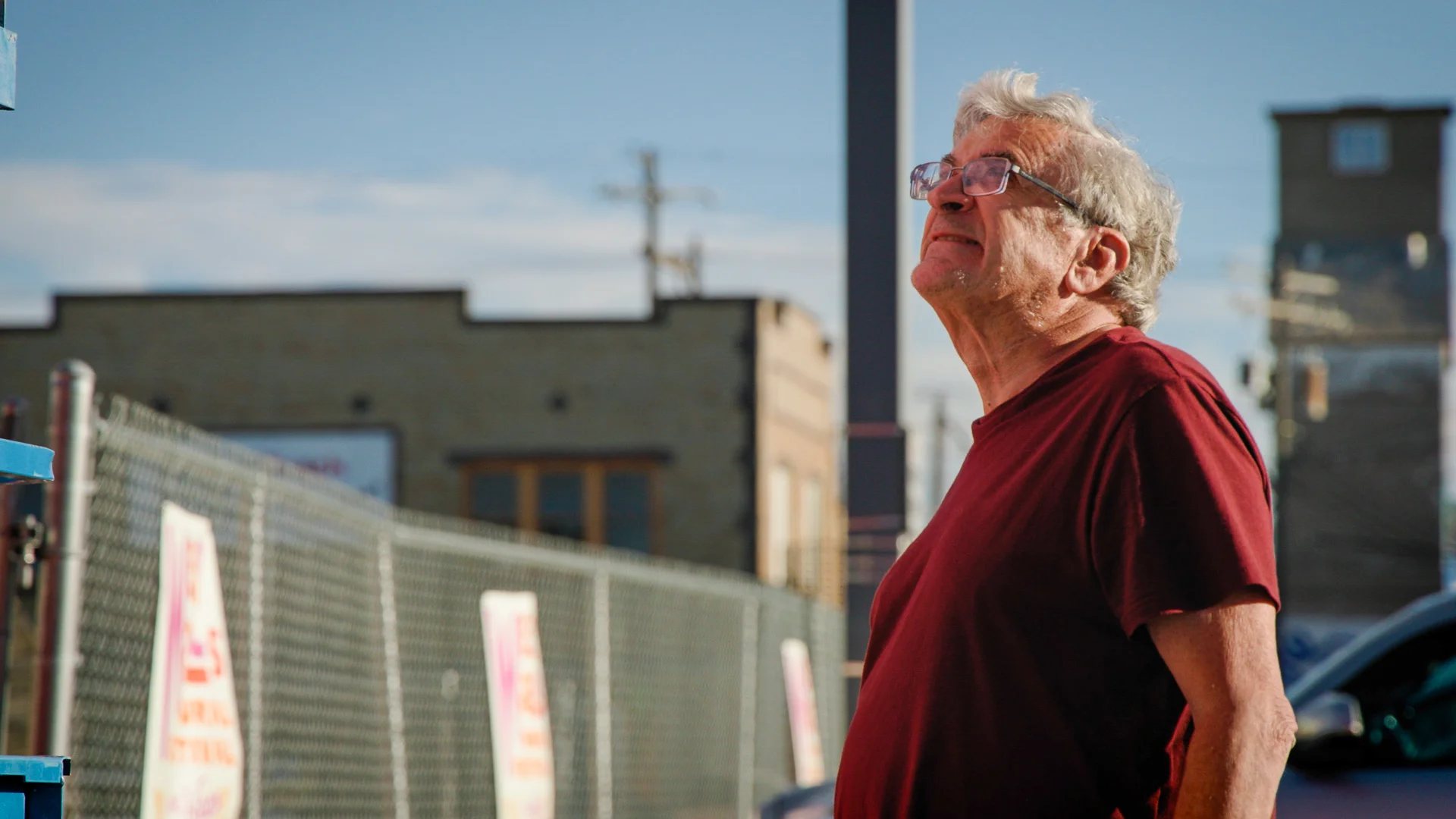 A festival-goer watches Harrison as he applies details to his mural. Photo: Cormac McCrimmon, Rocky Mountain PBS