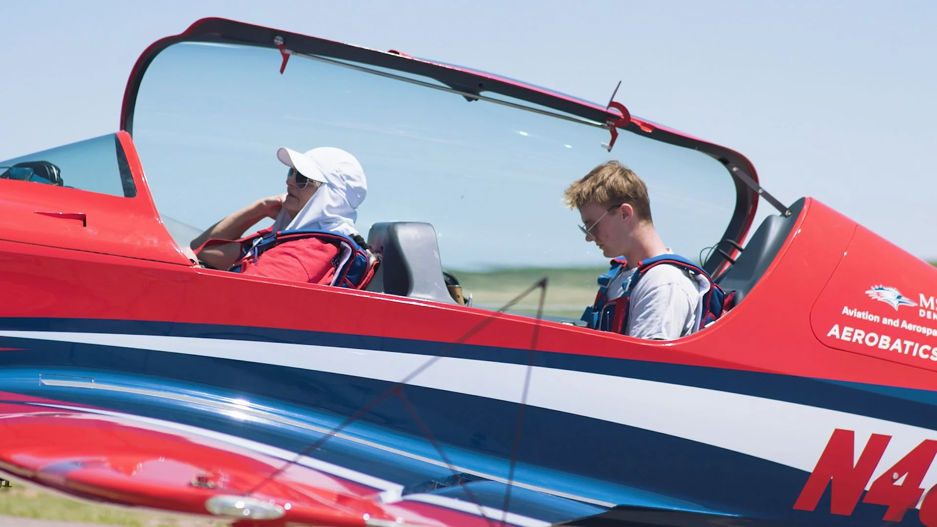 Kress (left) preps Shetterly (right) before a practice flight.  Photo: Chase McCleary, Rocky Mountain PBS