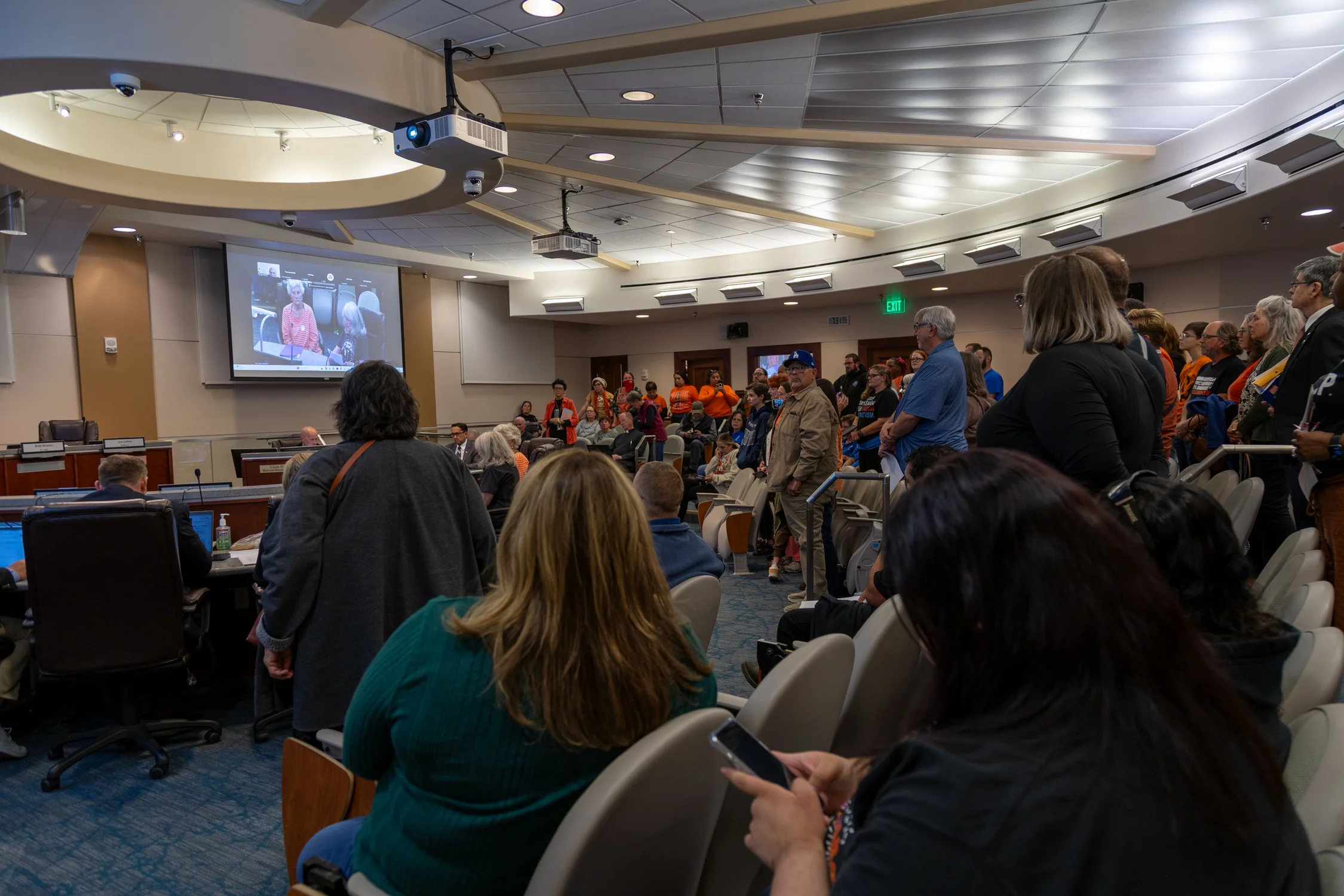 More than 30 people stood up during the reading of the open letter to show opposition to ICE using Pueblo's airport. Photo: Chelsea Casabona, Rocky Mountain PBS