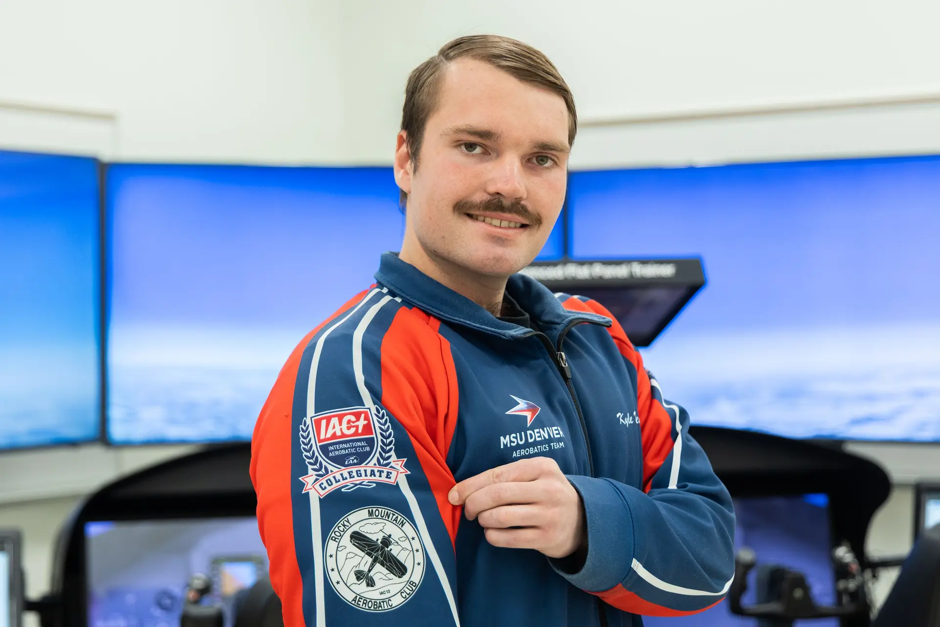 Wren, the team captain, poses in an MSU Denver Aerobatics Team jacket.  Photo: Chase McCleary, Rocky Mountain PBS