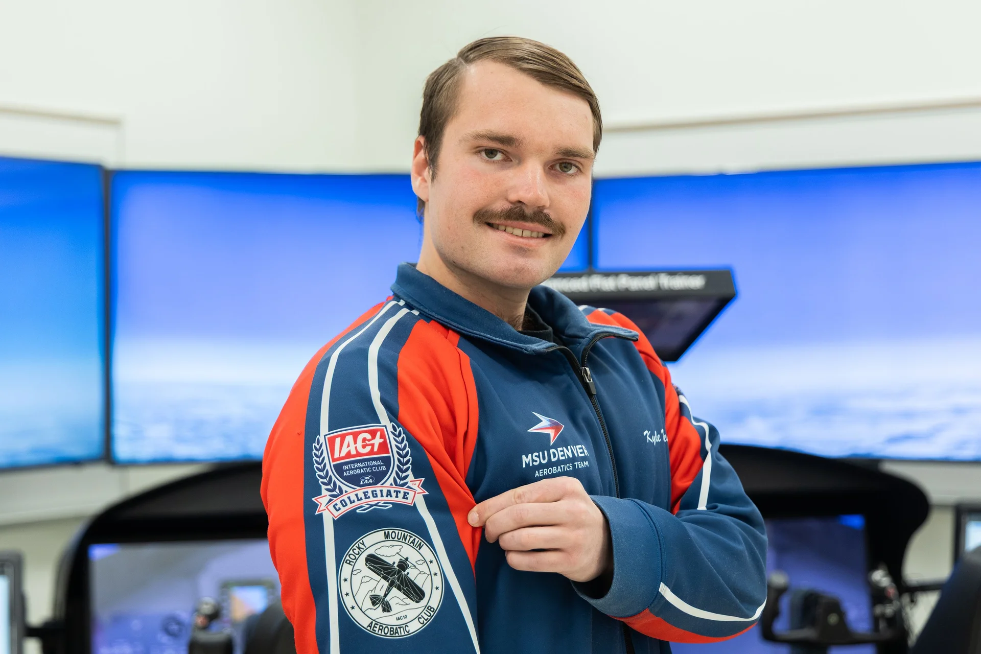 Wren, the team captain, poses in an MSU Denver Aerobatics Team jacket.  Photo: Chase McCleary, Rocky Mountain PBS