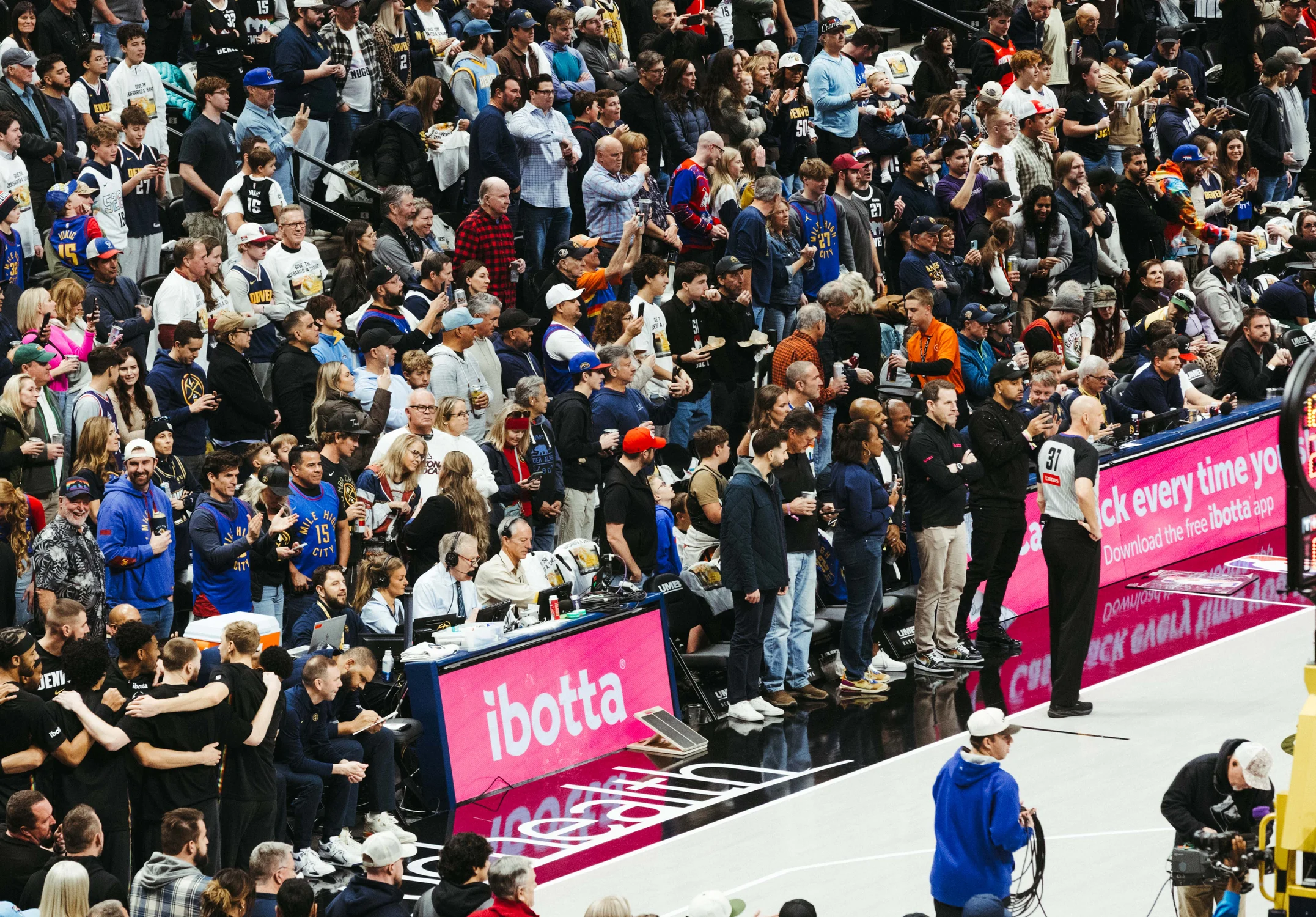 Marlowe, courtside behind the Ibotta advertisement, calls a Nuggets game Saturday, Dec. 20 at Ball Arena. Photo: Peter Vo, Rocky Mountain PBS