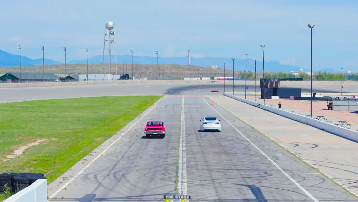 Gabardi in his Ford Falcon going head to head with a white Tesla. Photo: Chase McCleary Rocky Mountain PBS