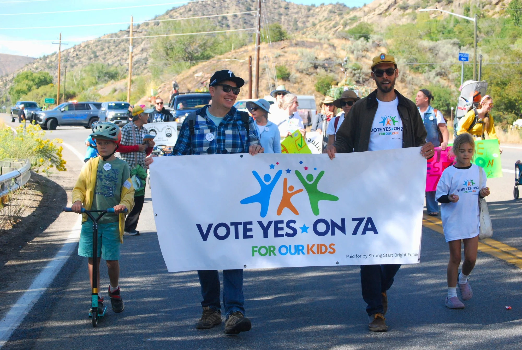 People hold a banner supporting the 7A ballot measure in the Roaring Fork Valley. If passed, 7A would implement a .25% sales tax on non-essential goods to support child care in the area. Photo courtesy Strong Start Bright Future Campaign