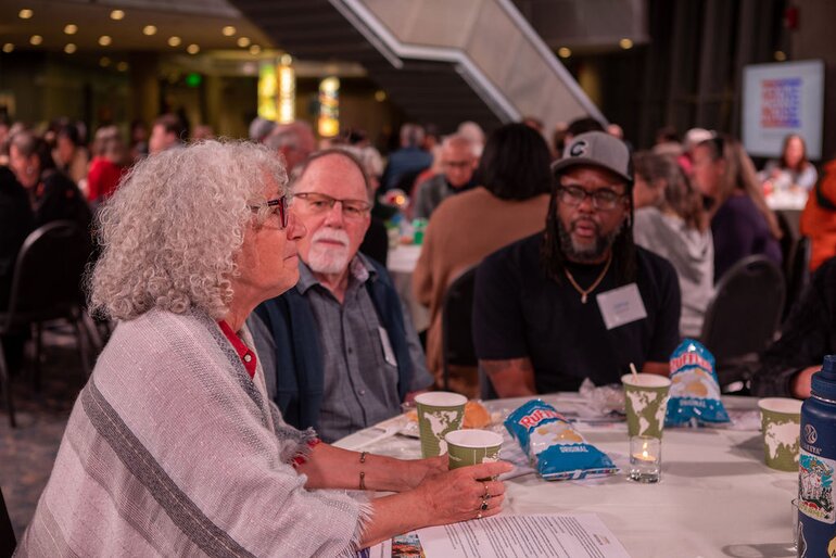Above the Noise event and people at table