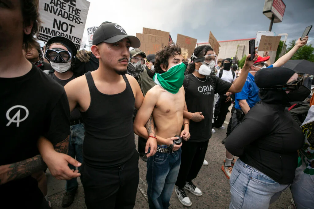 Protesters stand arm-in-arm. Photo: Kevin J. Beaty, Denverite