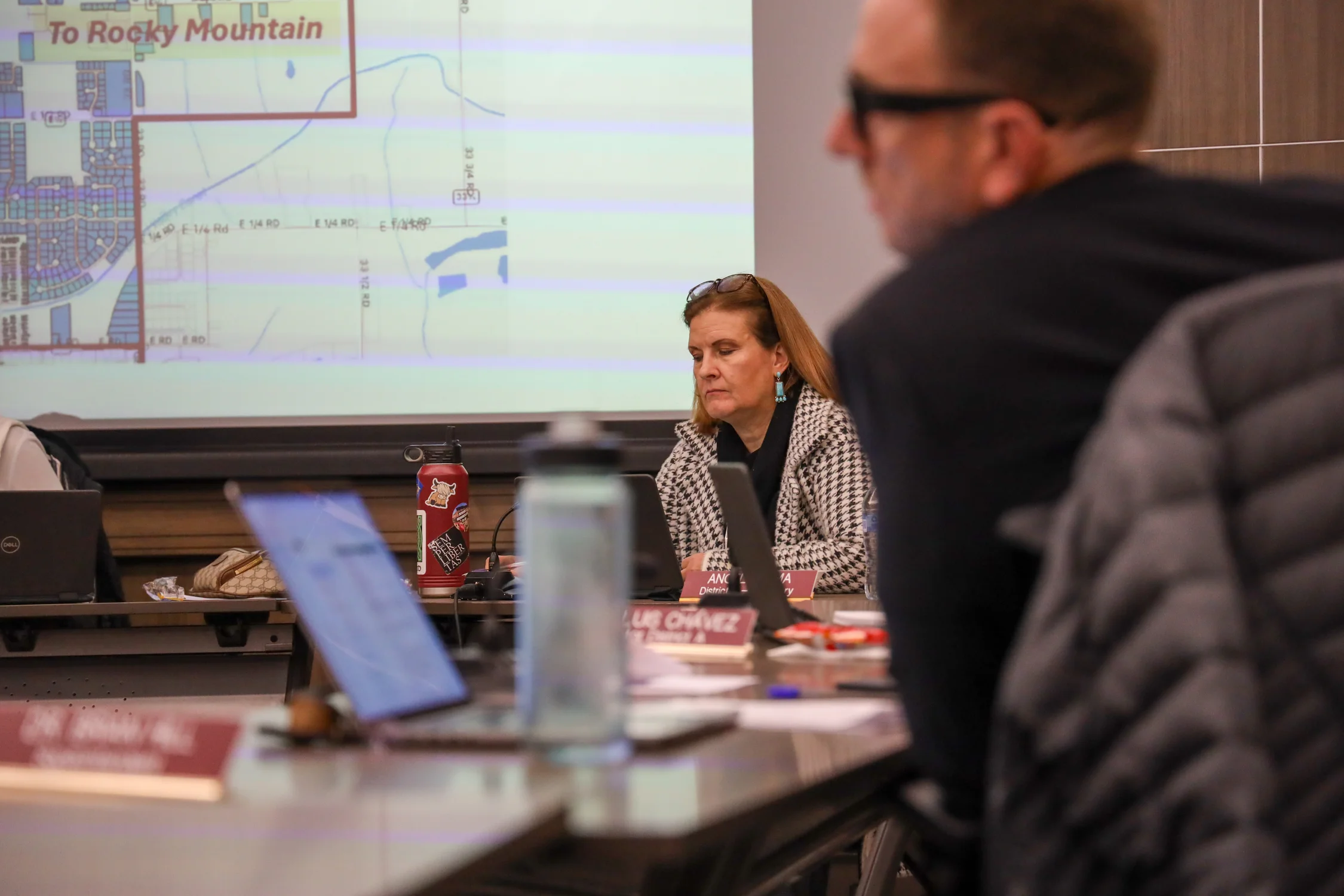 District 51 board secretary Angela Lema listens to a staff presentation on school boundary changes at the Dec. 10 meeting. In November, the school board voted five to zero to close three elementary schools in Grand Junction. Photo: Joshua Vorse, Rocky Mountain PBS