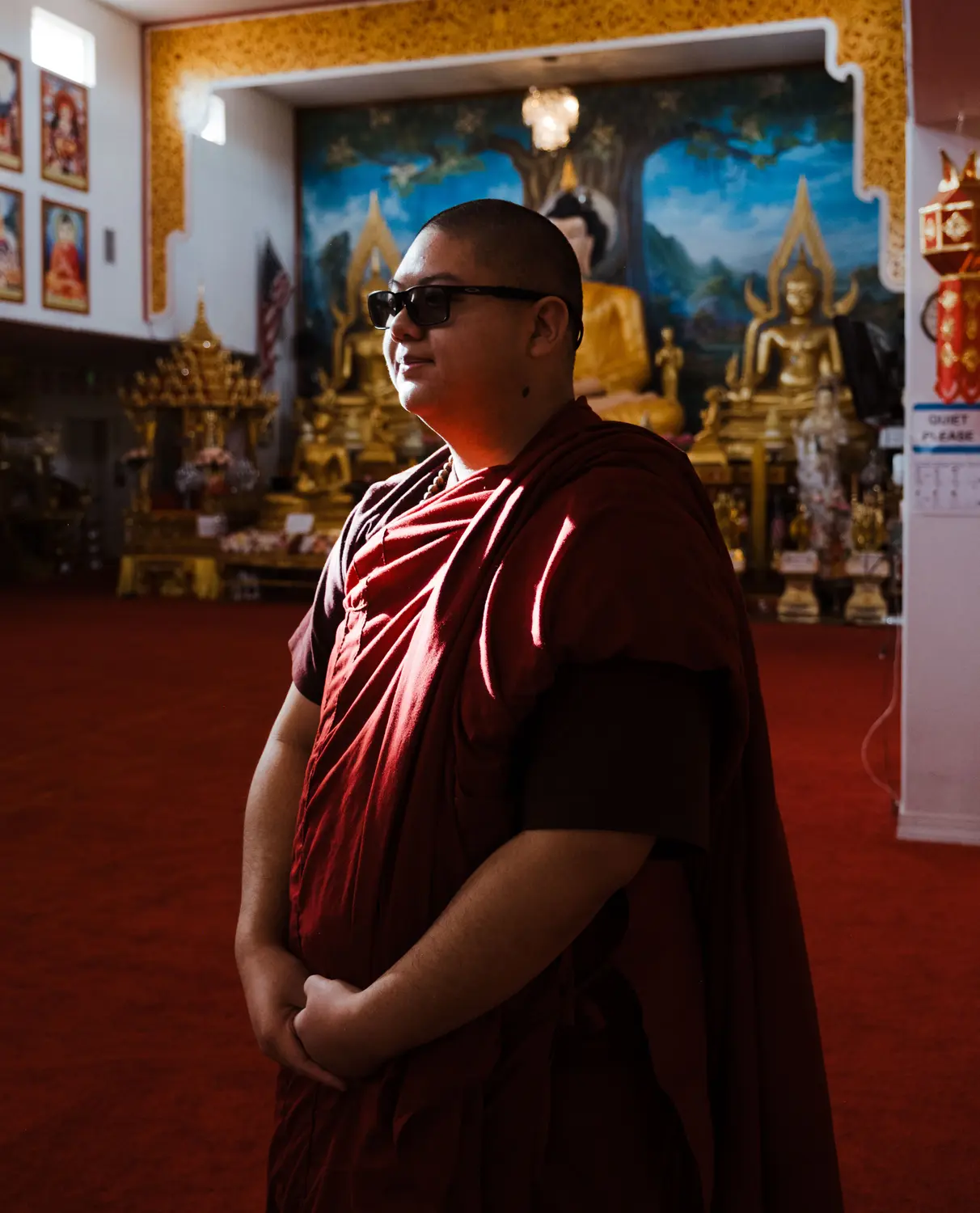 Ajarn Gavin stands inside of the vihāra. Photo: Peter Vo, Rocky Mountain PBS