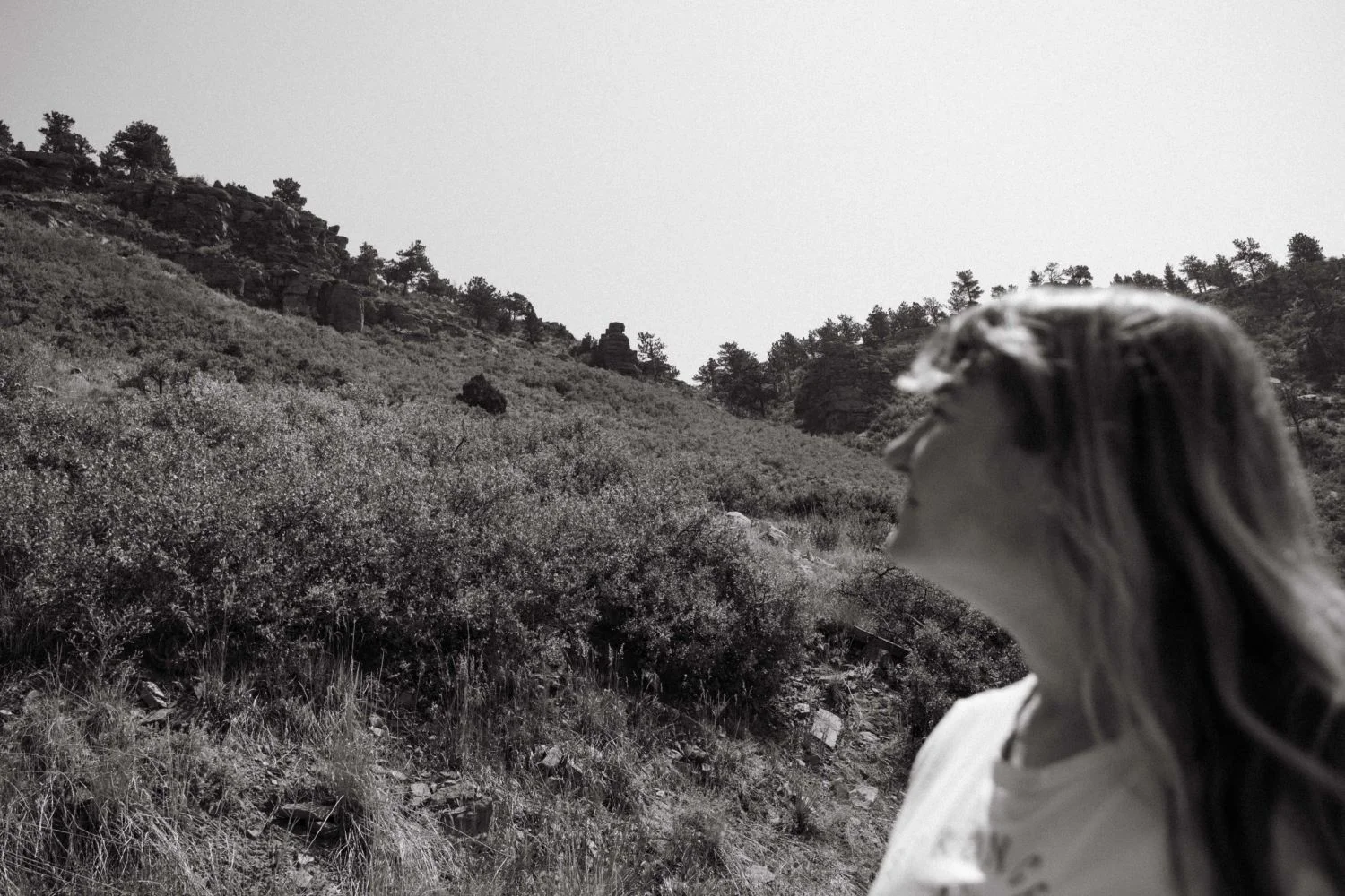 Bochenek looks up at the ridge that smoke was barreling down from, outside her home.  Photo: Peter Vo, Rocky Mountain PBS