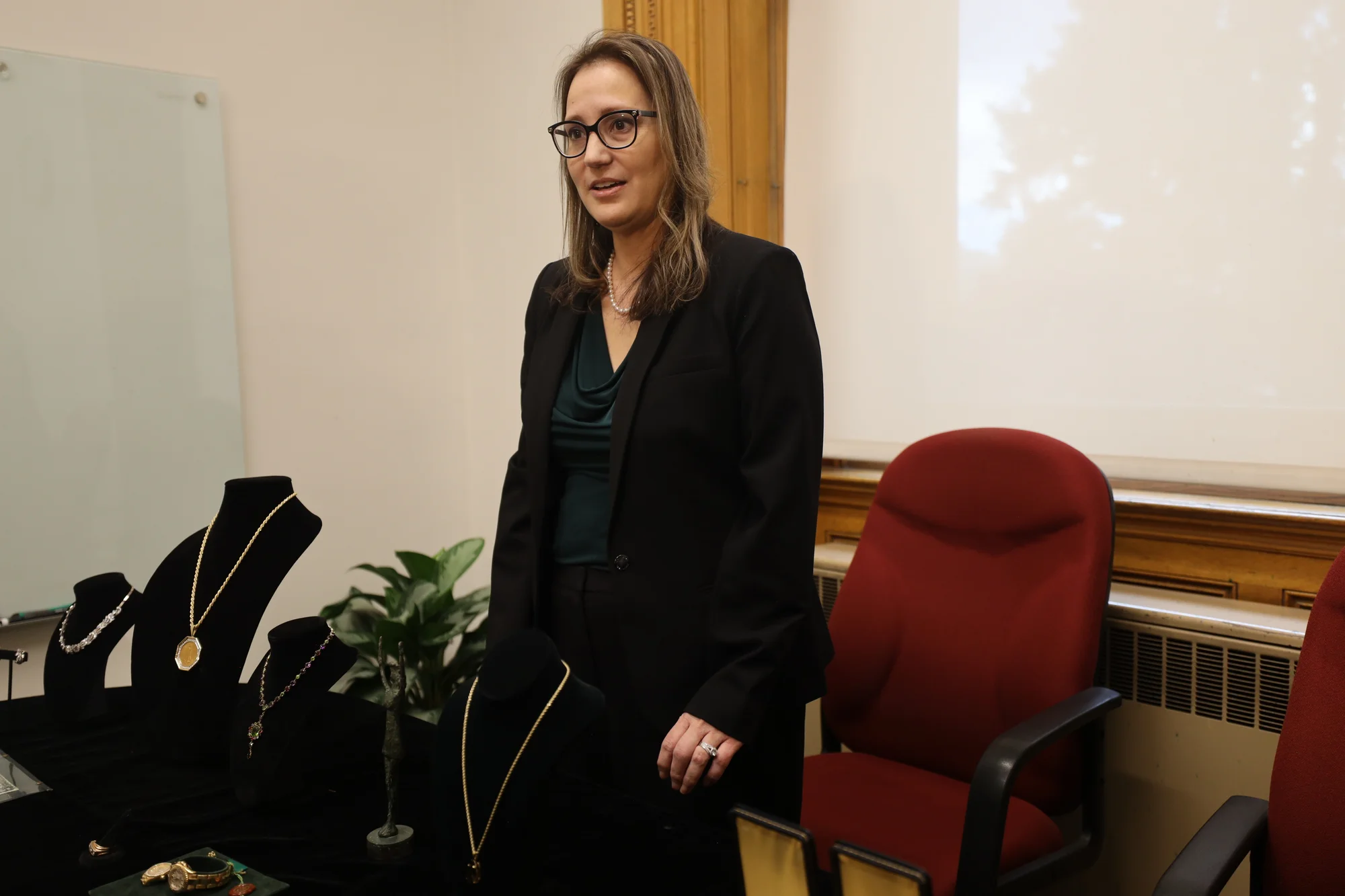 Unclaimed property director Bianca Garelli at the property viewing day, showing members of the media various items from the vault. Photo: Sarah Shoen, Rocky Mountain PBS