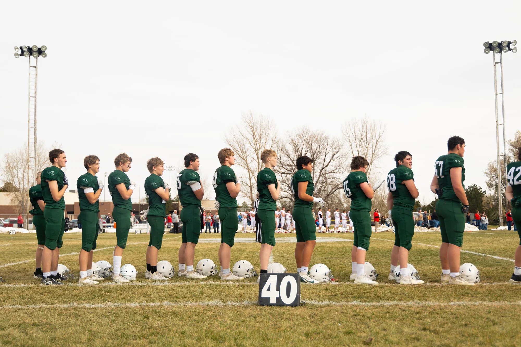 Stratton Eagles stand for the national anthem before the semifinal game against Otis. Photo: Chase McCleary, Rocky Mountain PBS