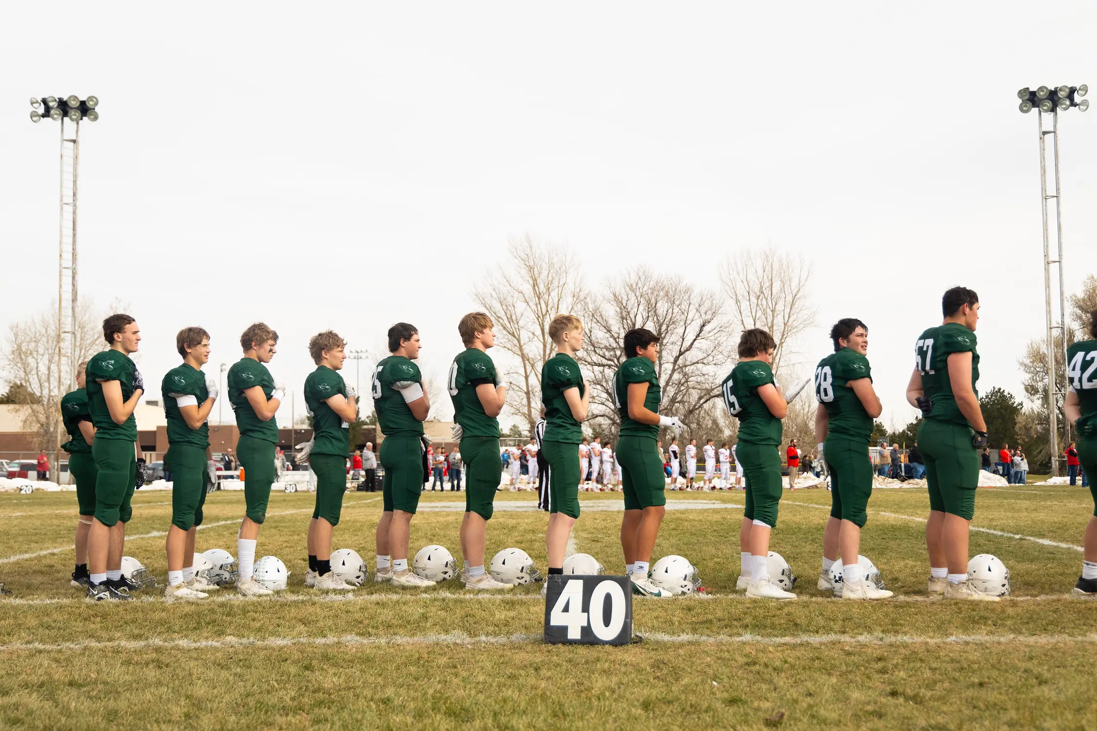 Stratton Eagles stand for the national anthem before the semifinal game against Otis. Photo: Chase McCleary, Rocky Mountain PBS