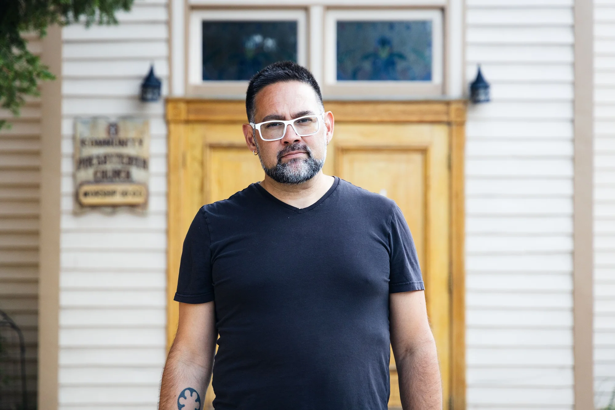 Rev. Jason Santos stands in front of the 149-year-old Community Presbyterian Church. Photo: Chase McCleary, Rocky Mountain PBS