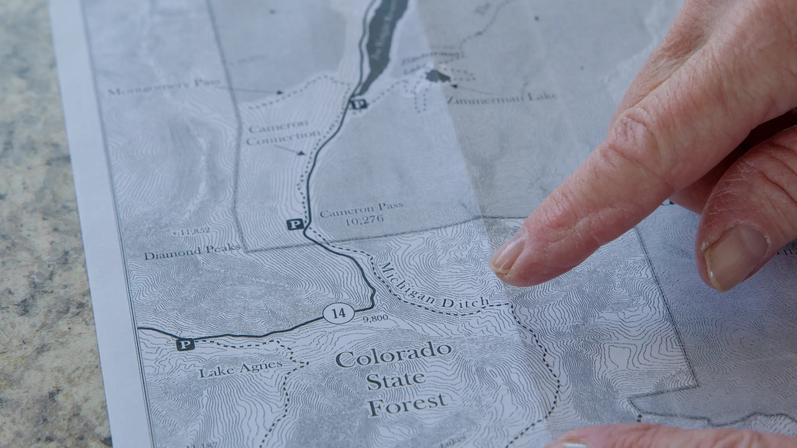 Karen Roth, founder of the Cameron Pass nordic ranger program, points to a map of the area. Cameron Pass, 70 miles west of Fort Collins, is home to over 30 cross-country ski and snowshoe trails. Photo: Cormac McCrimmon, Rocky Mountain PBS
