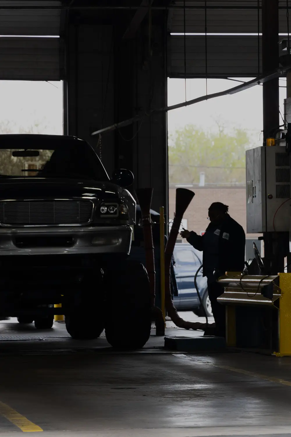 An employee at Air Care Colorado performs an emissions test in Denver. Photo: Cormac McCrimmon, Rocky Mountain PBS