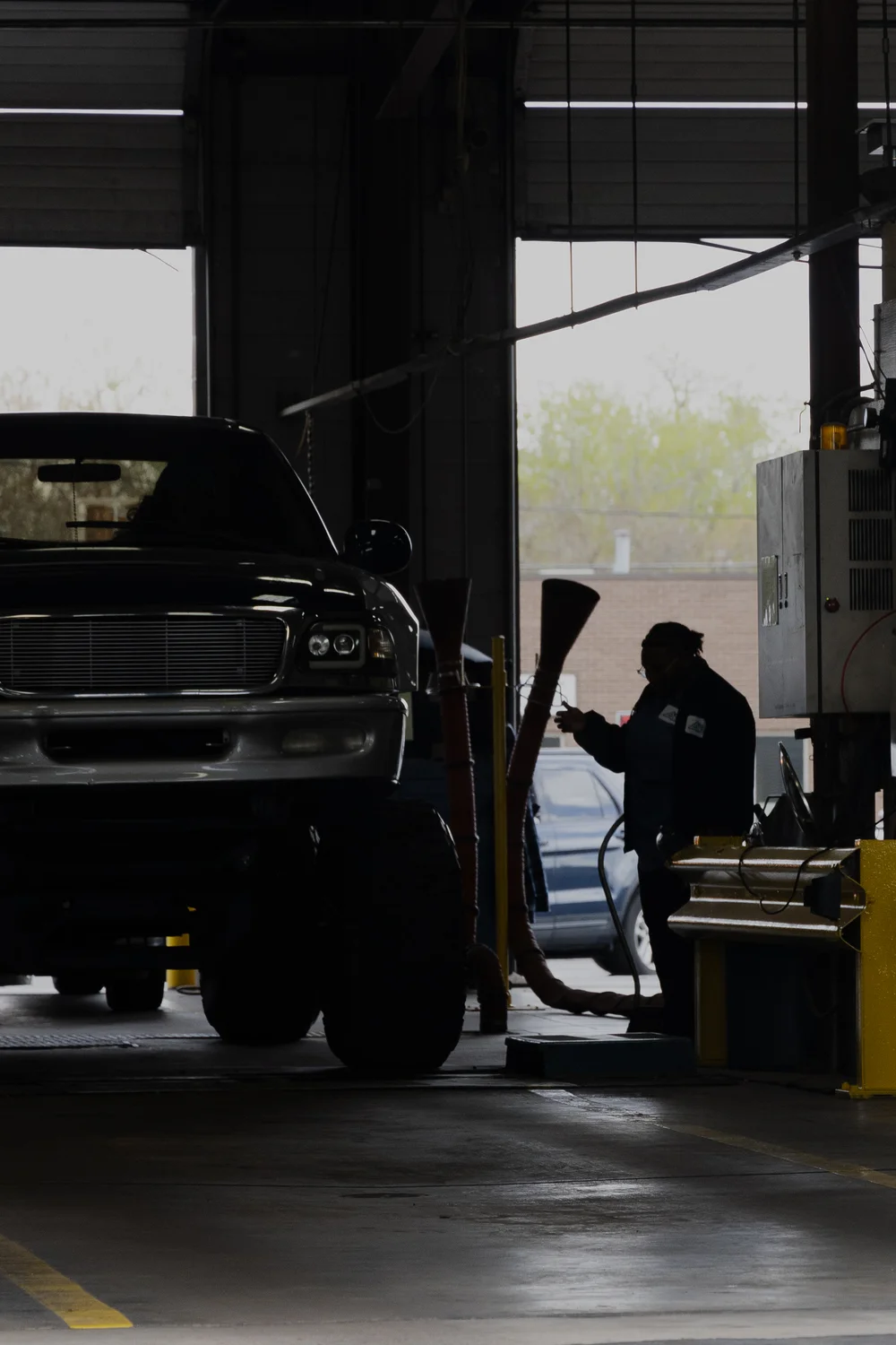 An employee at Air Care Colorado performs an emissions test in Denver. Photo: Cormac McCrimmon, Rocky Mountain PBS