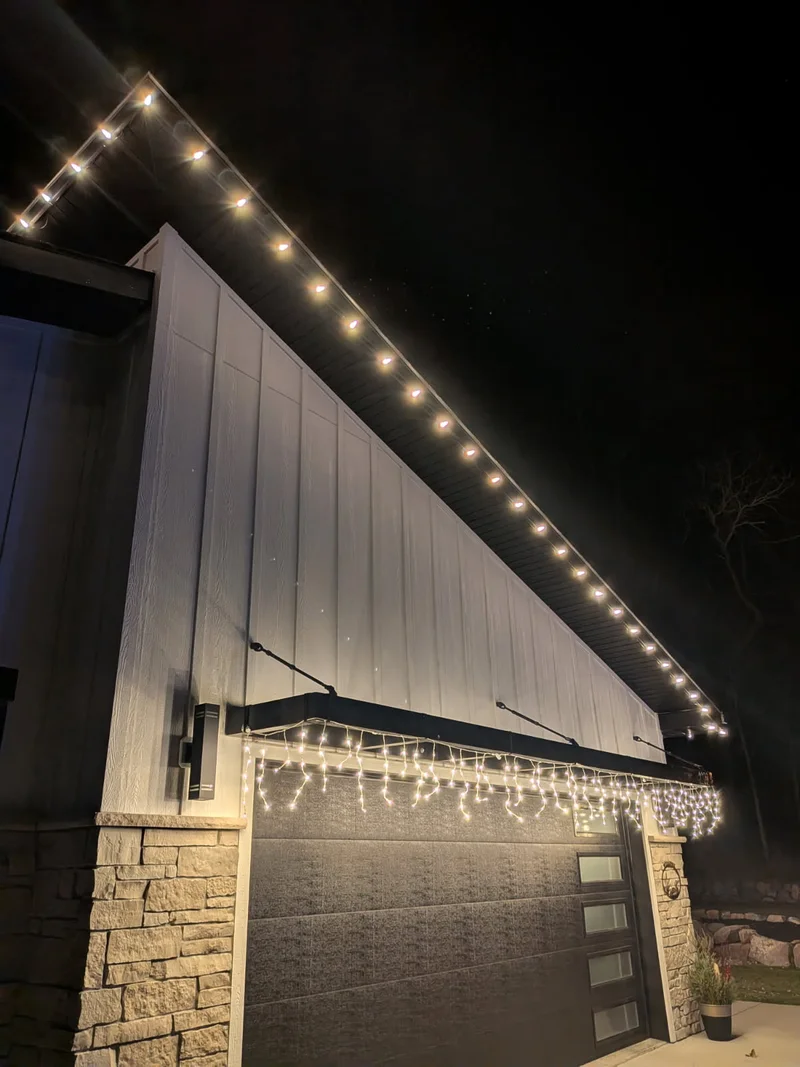 Perham-area home with warm string lights traced along every roofline