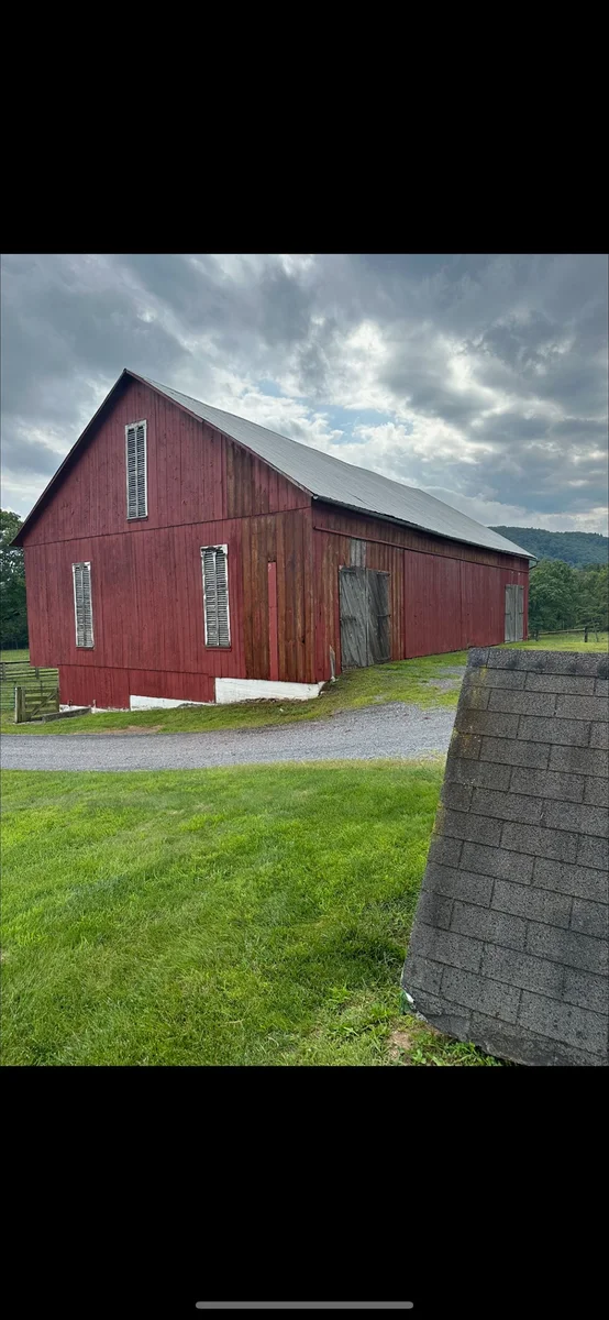 Before — Red barn exterior before and after restoration