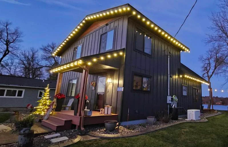 Perham-area home lit with warm white roofline lights
