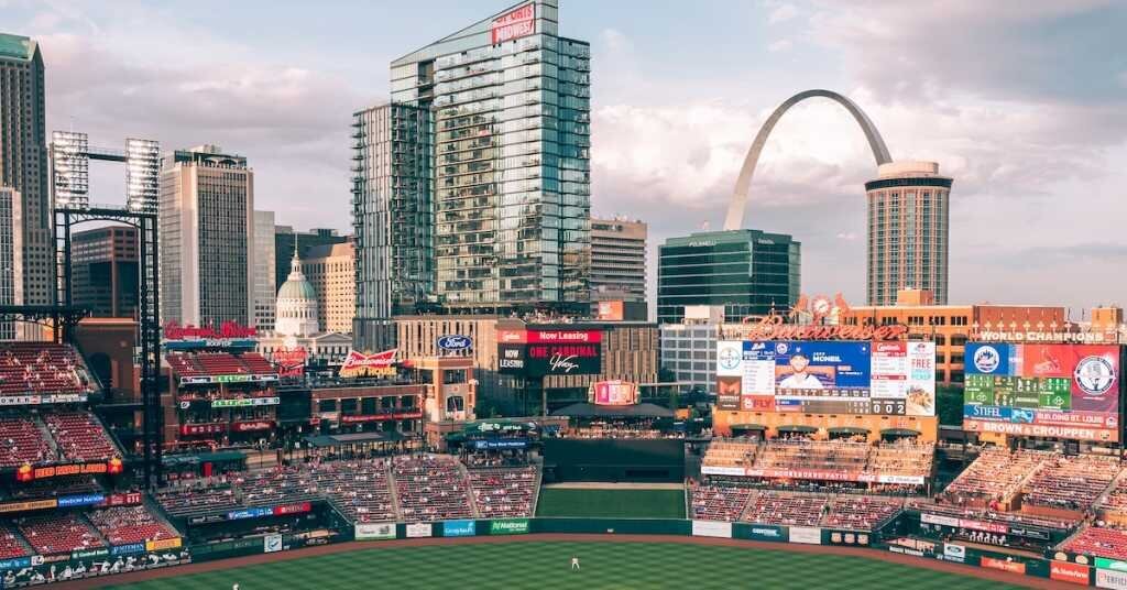 A baseball stadium with the Arch in the background