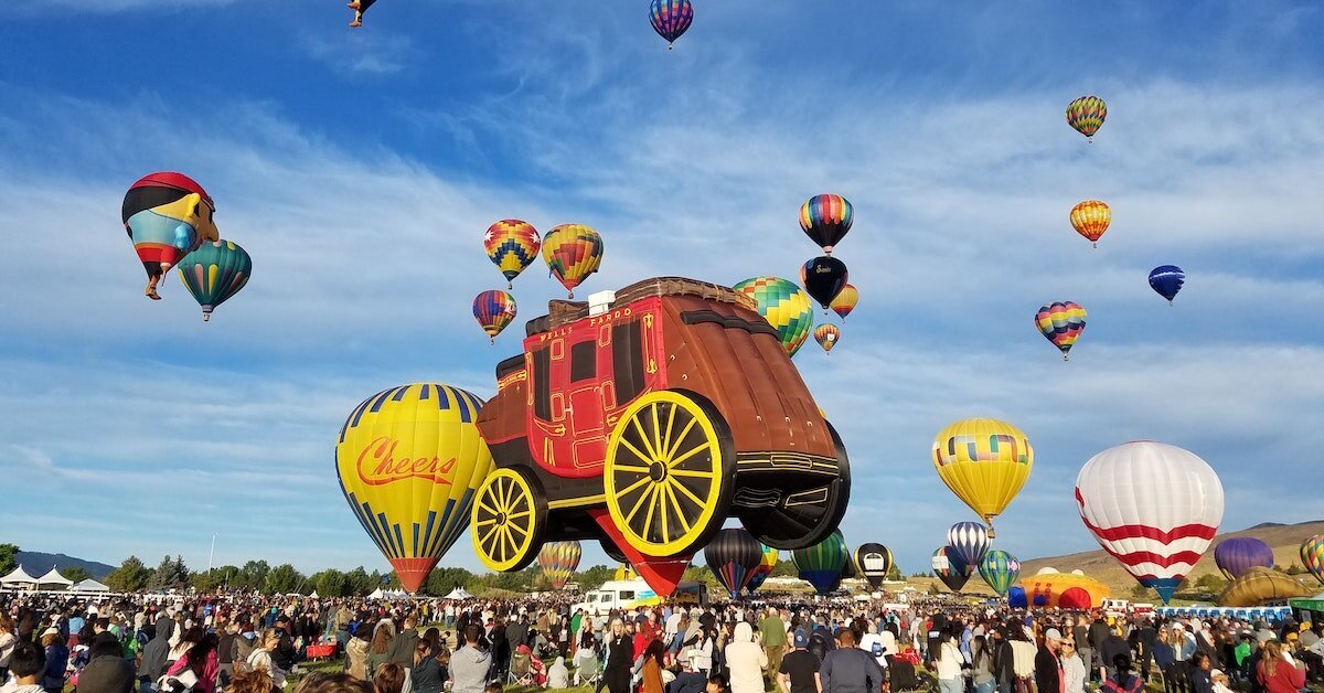 Reno's hot air balloon festival with balloons lifting a carriage into the air