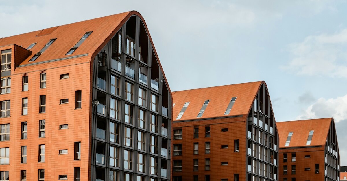 Brown, brick-built commercial real estate buildings that are multifamily apartments