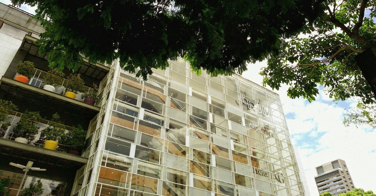 An office building with staircases with different offices showing through the windows