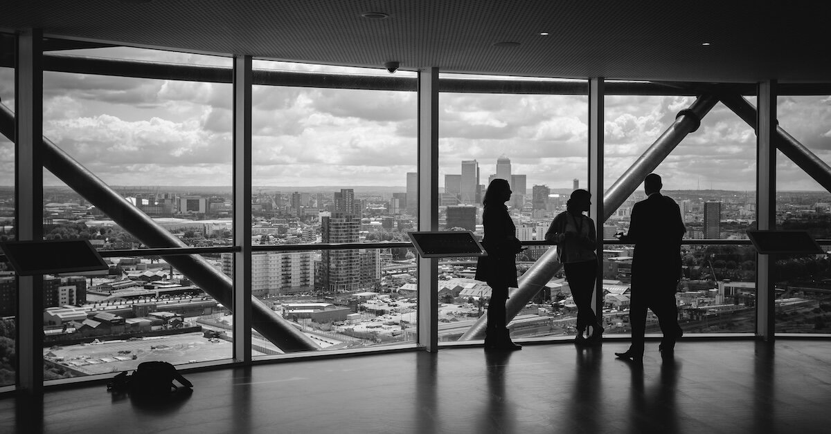 People standing looking out at a city view in a commercial office building