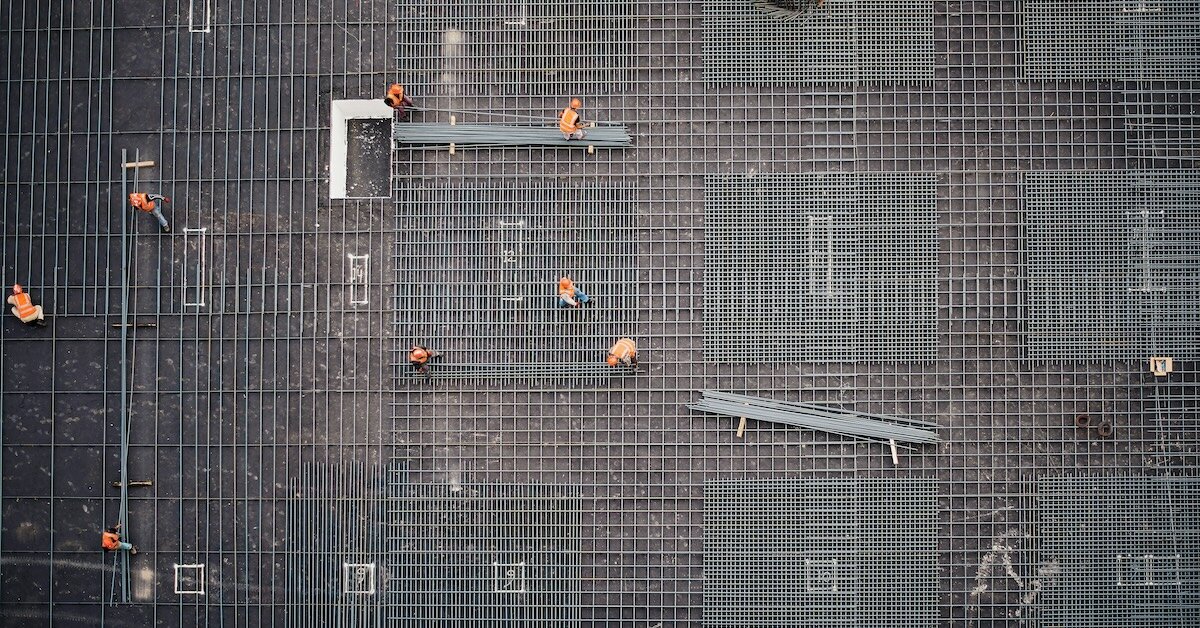 Construction workers working on an office to multifamily conversion property site